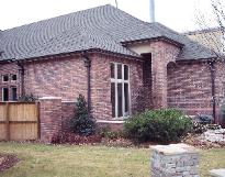 bronze conductor heads on brick
